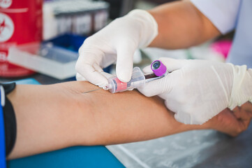 Close up hand of nurse, taking blood sample from a patient in the hospital.	