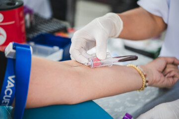 Close up hand of nurse, taking blood sample from a patient in the hospital.	
