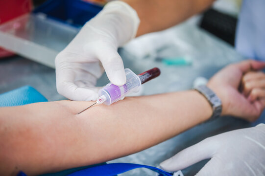Close up hand of nurse, taking blood sample from a patient in the hospital.	
