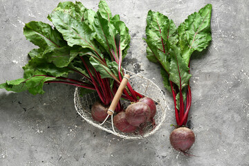 Basket with fresh beetroots on grey grunge background