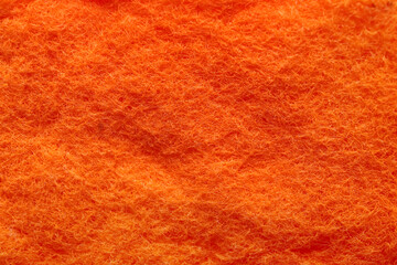 Texture of orange sponge as background, closeup