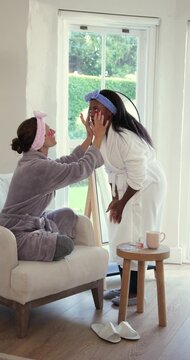 After examining red patches two women are applying them under eyes for skincare glow in mirror