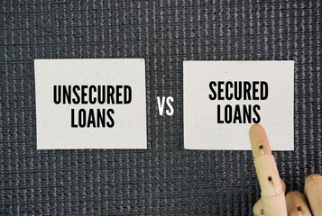 Papers with the words Secured vs Unsecured Loans. Business loan concept. Secured Loans offer lower...
