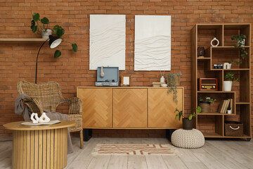 Interior of living room with record player on commode, armchair and shelf unit