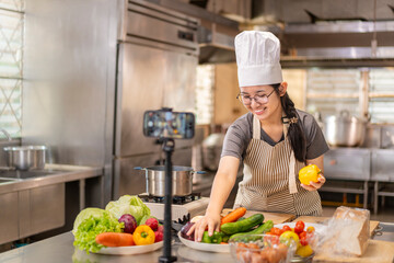 Smiling Female Chef Recording Cooking Video in Kitchen