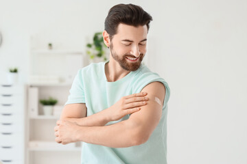 Young man with applied medical patch after vaccination in clinic
