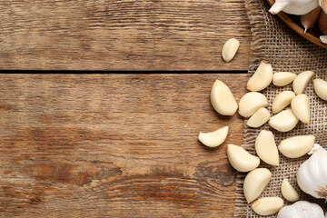 Fresh garlic cloves on wooden background