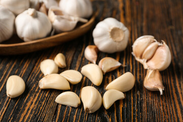 Fresh garlics and cloves on wooden background, closeup