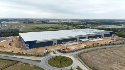 Aerial drone view of large distribution centers, warehouses, business park with heavy goods...