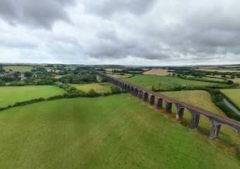 Aerial drone photo large viaduct bridge train railway in rural green landscape, England UK,...