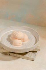 A scoop of vanilla ice cream in a bowl with an aesthetic stone motif in the art of photography