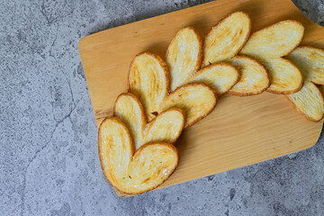 Top view of many mini pies on wooden cutting board isolated on Grey or Grey cement background. High...
