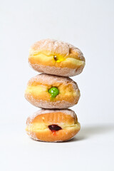 Close up view of one bomboloni doughnut with strawberry filling isolated on white background. clipping path. homemade. Italian stuffed donuts.