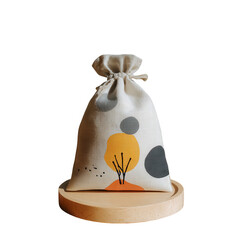 Beige drawstring bag with abstract print, sits on wooden disc