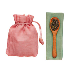 Pink fabric pouch with loose leaf tea in wooden spoon on green napkin