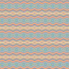 Soft-toned diamond and chevron seamless pattern in pastel peach, blue, and cream. Perfect for textiles and elegant backgrounds.