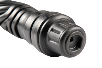 Close-up of a dark, cylindrical device with textured exterior and a black connector