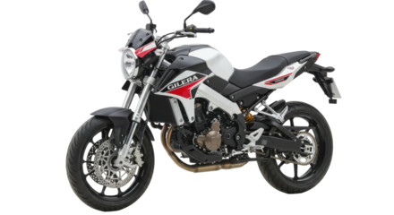 Sleek motorcycle parked on a city street with blurred urban background and sunlight