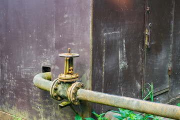 Iron water pipe with valve coming out of pumping station