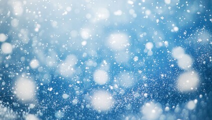 Abstract winter scene with light-filled snowflakes.  Soft-focus bokeh effect of snowy blue background