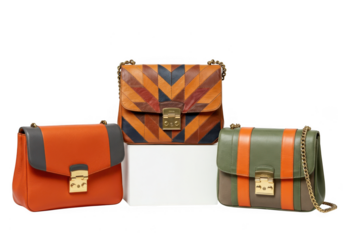 Three stylish handbags with striped and patterned designs isolated on transparent background