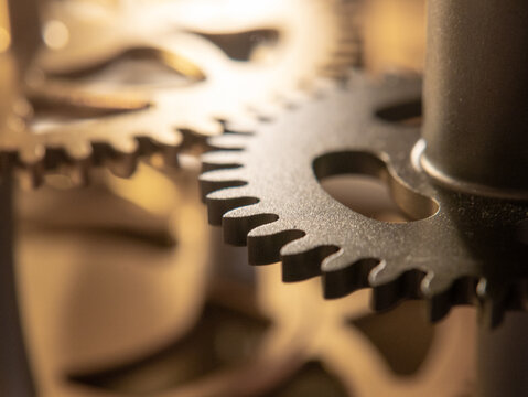Meshing transmission gears under golden background light