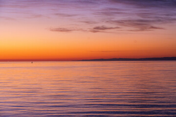 Ferry dock in Geelong for the Spirit of Tasmania with industrial cranes in the background as the sun sets over the Bass Strait in Victoria, Australia