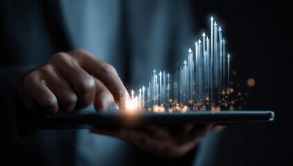 Businessman using a tablet to control global business growth, with data graphs and financial charts displaying rising arrows on a holographic screen in a dark background. This.