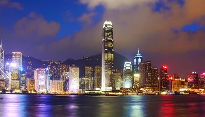 Obraz premium Radiant Metropolis: The dazzling luminosity of Hong Kong's night skyline reflecting on water
