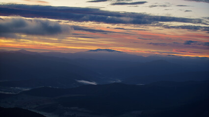 Sunrise from Mount Buffalo with beautiful cliffs, mountains, tree, clouds and mist as the day begins in Victoria, Australia on a cold winter morning