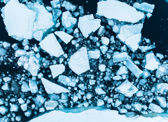 Top down aerial view of ice shelfs floating in the ocean in the arctic north of Svalbard, Norway