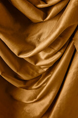 Obraz premium Golden satin silk with crumpled abstract texture background. Material textile surface. Copy space