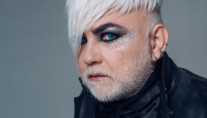 Transgender man with makeup. Bearded mature trans with eyeshadow. Transgender identity. Gender...