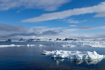 Floating ice on the ocean with mountains in the background in the arctic of Svalbard, Norway © Reto Ammann