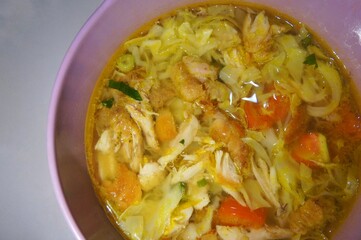 Ayam Soto, or Soto Ayam in Indonesia, is a traditional Indonesian dish featuring chicken, rice vermicelli, peanuts, and turmeric, with the main ingredient being the broth.