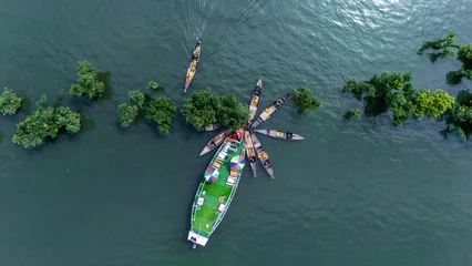 Selbstklebende Fototapeten Grün Blau Areal view landscape  of Tanguar Haor, Sunamganj, Bangladesh. Traditional boats with a houseboat at the Tanguar Haor in Sunamganj, a famous tourist spot in Bangladesh  © Zakir Hossain