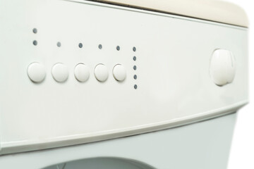 Closeup view of a knob and control panel button on a washing machine. Home appliance