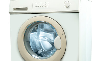 Closeup view of a washing machine with a knob and control panel button isolated over a white...