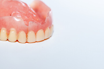 
Old denture on a white background.