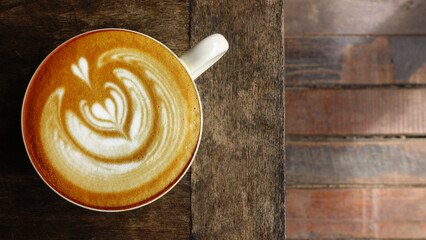  a cup of latte art coffee on wooden background                                                                                                                                                         