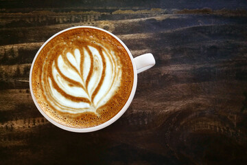  a cup of latte art coffee on wooden background                                                                                                                                                         