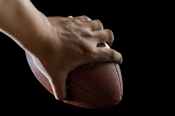 American football player holding the ball during the game in an American football stadium. Concept of sport