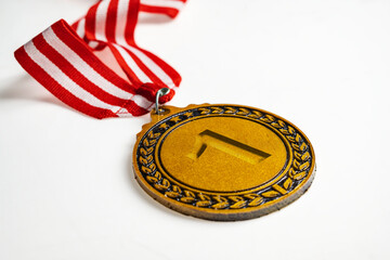 Closeup view of the 1st golden award medal suspended from a red and white striped ribbon isolated...