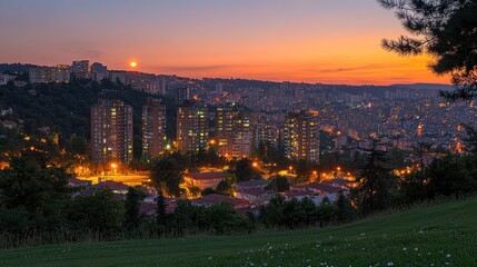 Cityscape at twilight, illuminated buildings, hills
