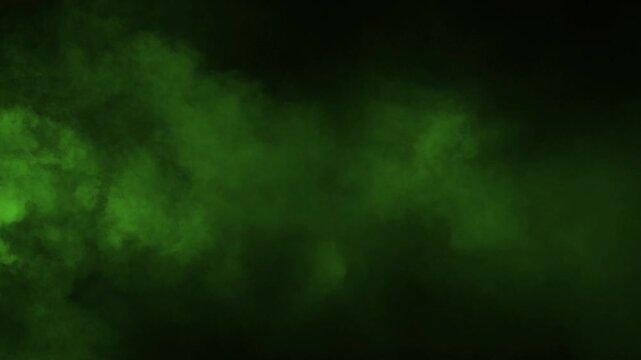 A jet of thick green smoke shoots across the screen from the side on a black background. Ideal visual effect for overlays, transitions, and dynamic motion graphics