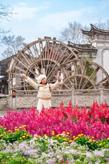 Young female tourist enjoys traveling at Lijiang Ancient Town, The famous tourist destination at Yunnan Province, China