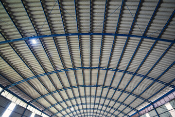 Interior view of the ceiling of a large metal structure in the warehouse building