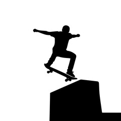 Silhouette of a skateboarder performing an aerial maneuver over a low obstacle.