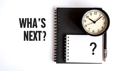 Planning, time management, and questioning. Black notebooks, a clock, and a pen rest on a white surface.  The words "What's Next?" are prominent
