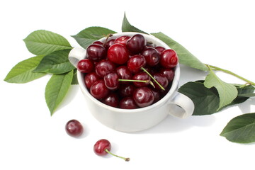 There is a pile of ripe juicy cherries on the plate.